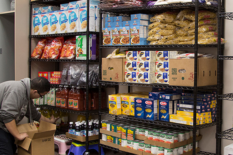 person stocking food pantry