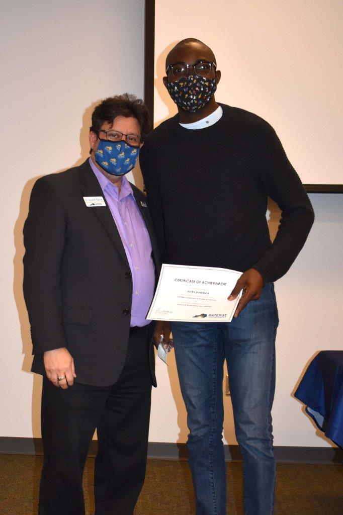 student with college president at dean's list celebration