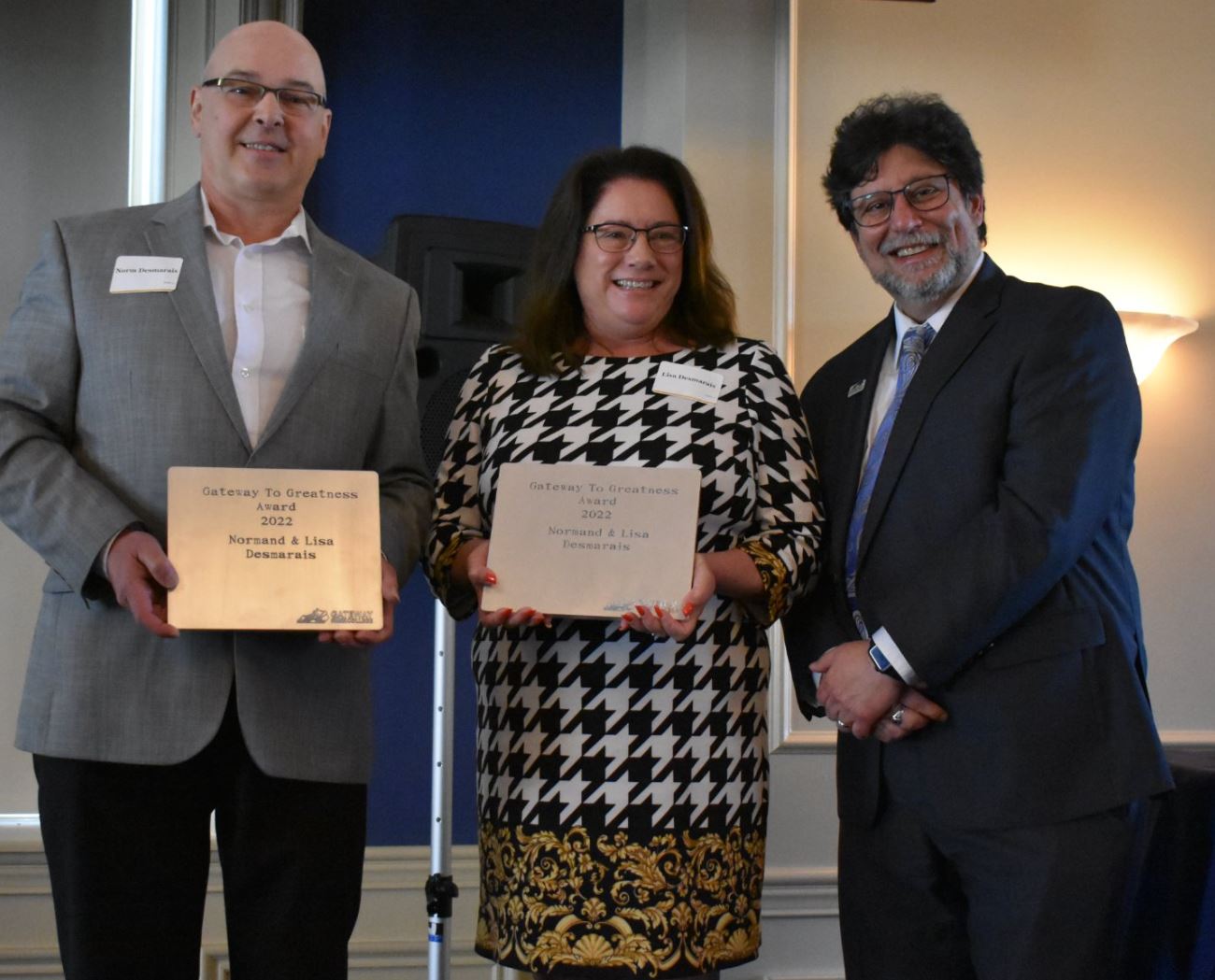 Norm and Lisa Desmarais accept award from Dr. Fernando Figueroa 