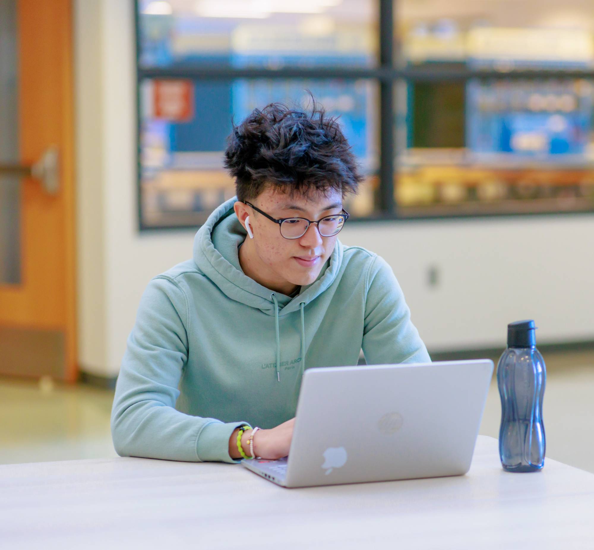 Male student looking at a computer.