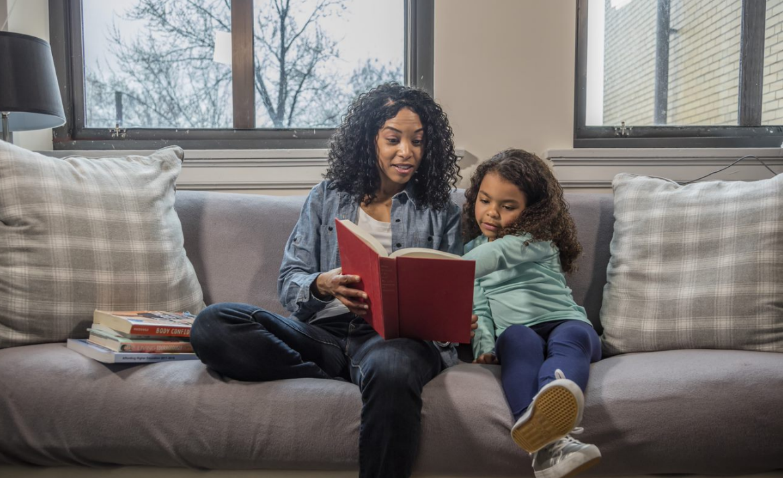 mother and daughter reading a book