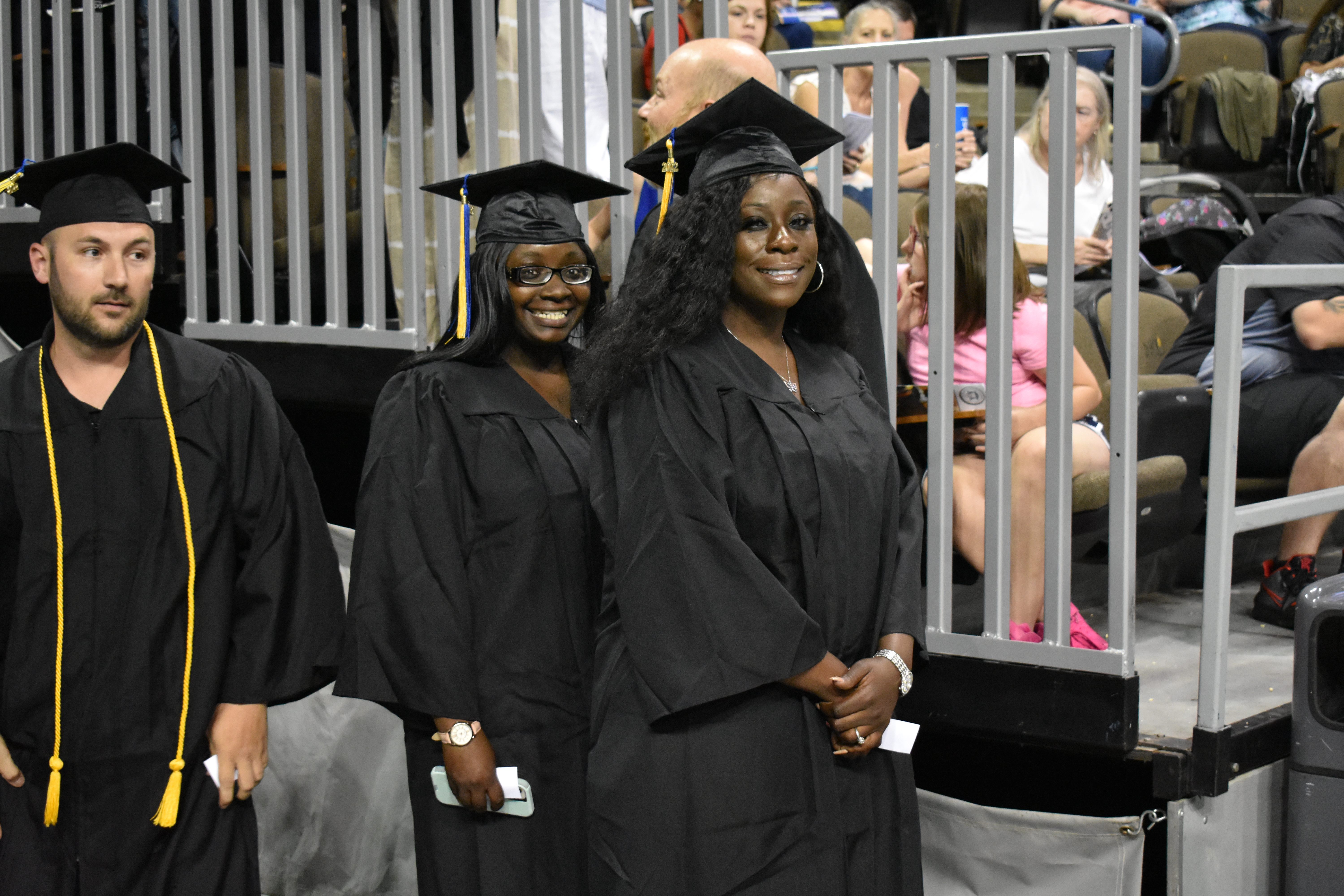 3 Students preparing to walk the line at Graduation. 