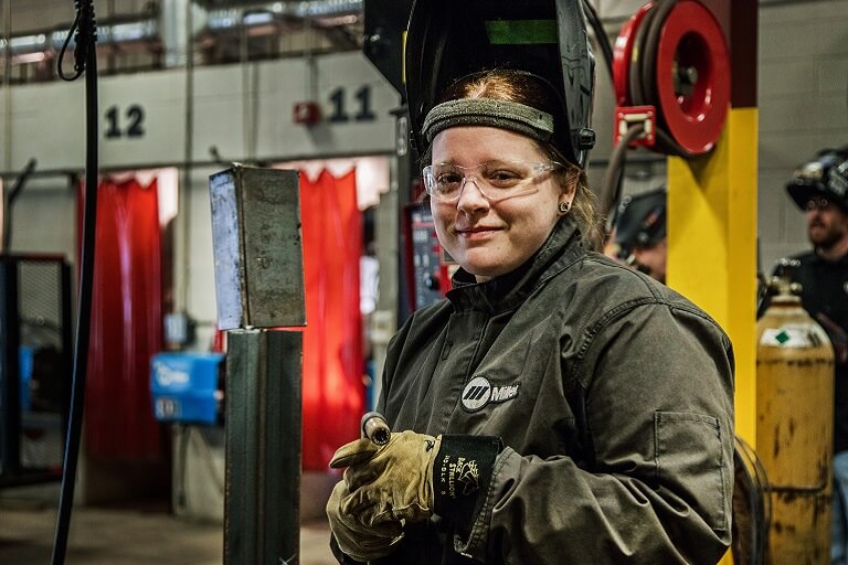 female welding student in class