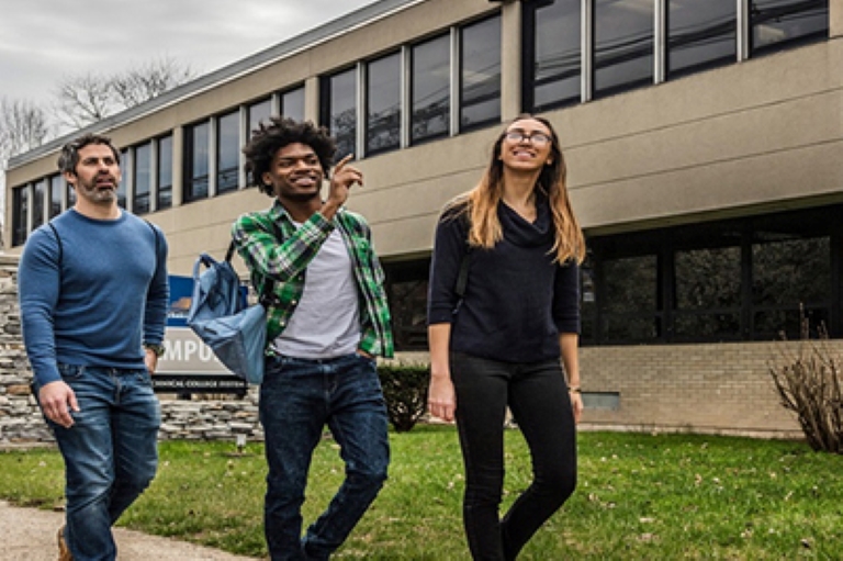 3 students walking outside