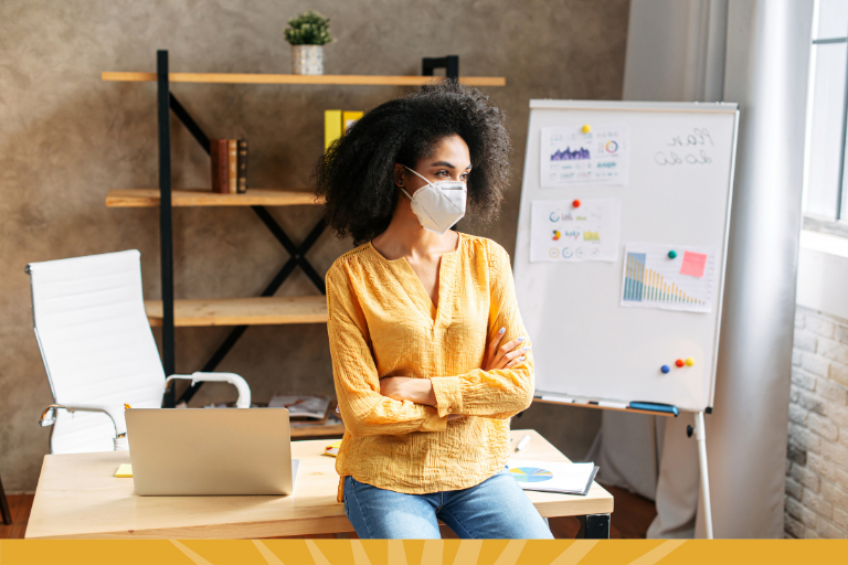 employee at desk with mask on