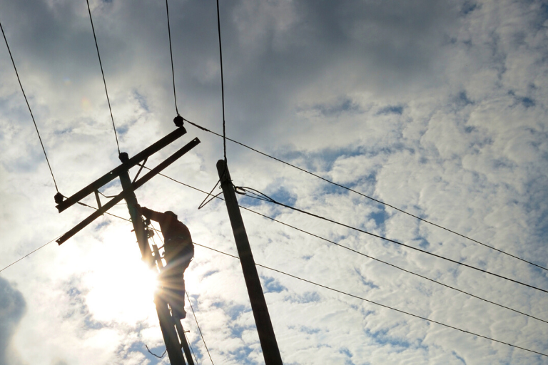 lineworker on utility pole